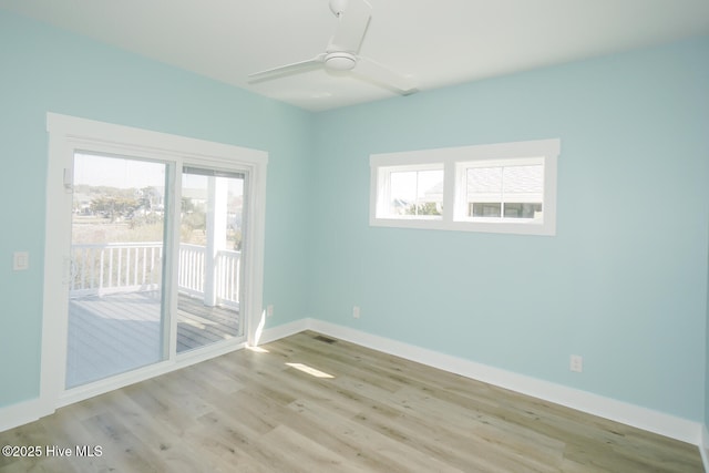 5228 E Beach Dr, Oak Island, NC 28465 - unfurnished room featuring baseboards, ceiling fan, light wood-type flooring, and plenty of natural light