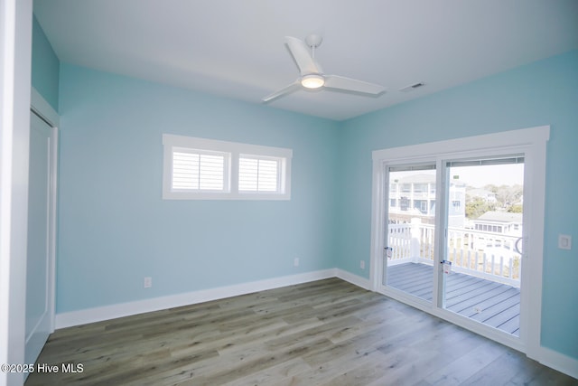 5228 E Beach Dr, Oak Island, NC 28465 - empty room featuring a ceiling fan, visible vents, baseboards, and wood finished floors