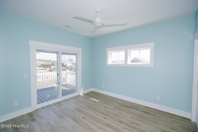 5228 E Beach Dr, Oak Island, NC 28465 - empty room featuring baseboards, visible vents, wood finished floors, and plenty of natural light