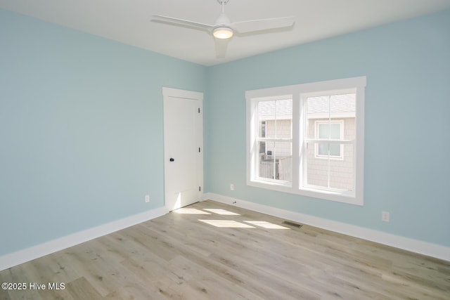 5228 E Beach Dr, Oak Island, NC 28465 - empty room with wood finished floors, baseboards, ceiling fan, and visible vents