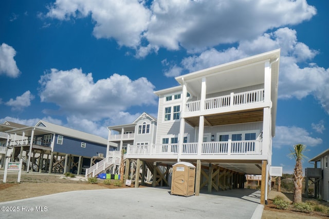 5228 E Beach Dr, Oak Island, NC 28465 - coastal home with driveway and a carport