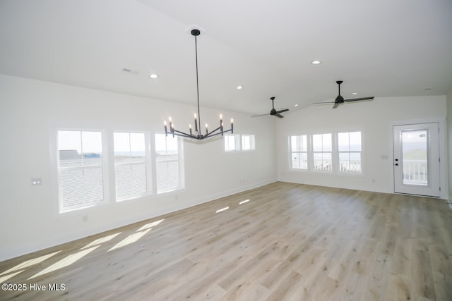 5228 E Beach Dr, Oak Island, NC 28465 - interior space with light wood finished floors, ceiling fan with notable chandelier, lofted ceiling, baseboards, and recessed lighting