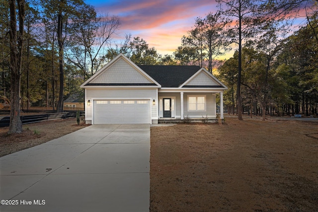 view of front facade featuring a garage and covered porch