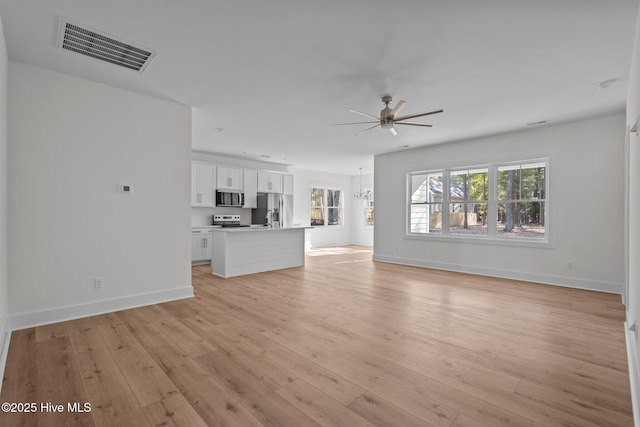 unfurnished living room featuring light hardwood / wood-style floors and ceiling fan