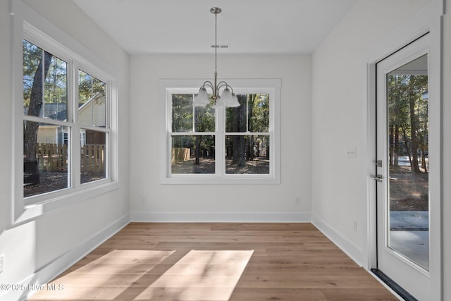 unfurnished sunroom featuring a notable chandelier