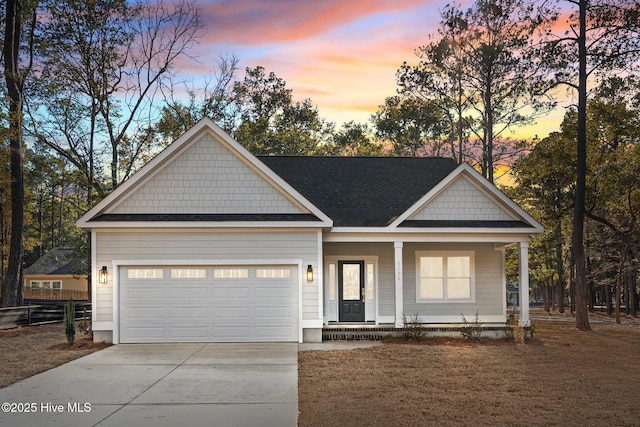 view of front of home featuring a garage and a porch