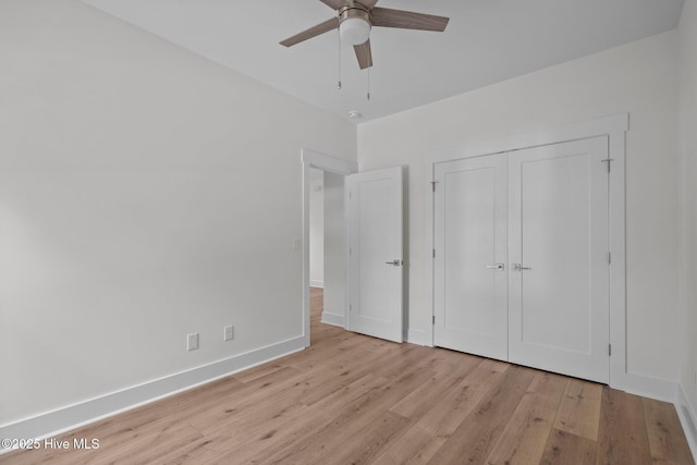 unfurnished bedroom featuring ceiling fan, a closet, and light hardwood / wood-style flooring