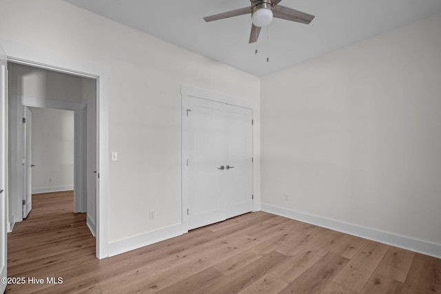 unfurnished bedroom with ceiling fan and light wood-type flooring