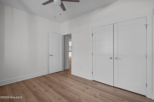 unfurnished bedroom with ceiling fan, light hardwood / wood-style floors, and a closet