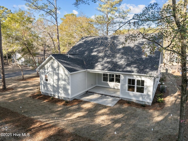 rear view of house with cooling unit and a patio area