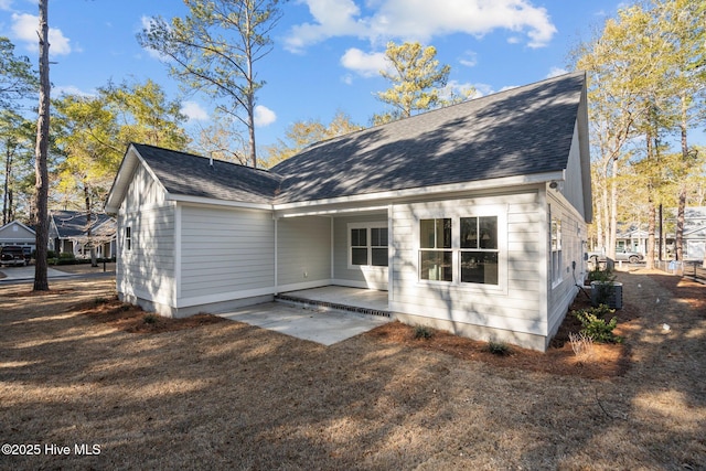 rear view of house with cooling unit and a patio area