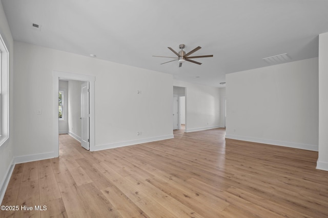 empty room with ceiling fan and light hardwood / wood-style flooring