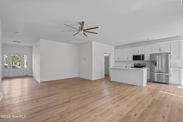 interior space featuring sink, light hardwood / wood-style flooring, and ceiling fan