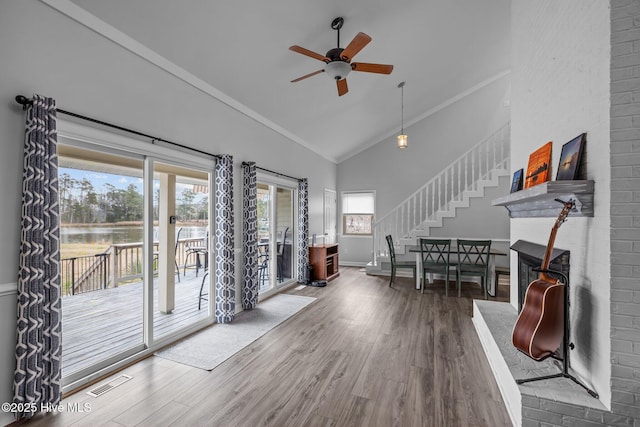 interior space featuring high vaulted ceiling, a wealth of natural light, wood finished floors, and visible vents