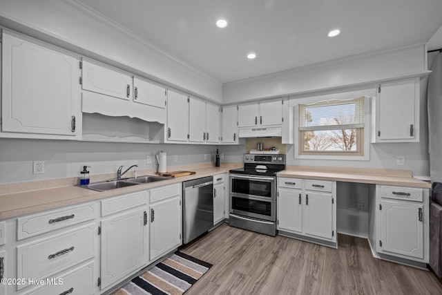 kitchen featuring light wood finished floors, appliances with stainless steel finishes, under cabinet range hood, white cabinetry, and a sink