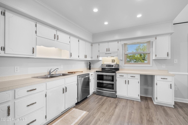 kitchen featuring appliances with stainless steel finishes, a sink, under cabinet range hood, white cabinetry, and ornamental molding