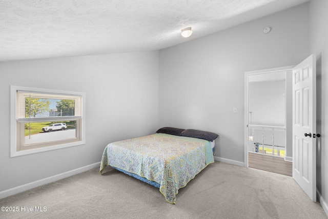 bedroom featuring carpet floors, baseboards, and a textured ceiling