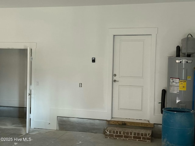 interior space featuring water heater and concrete flooring