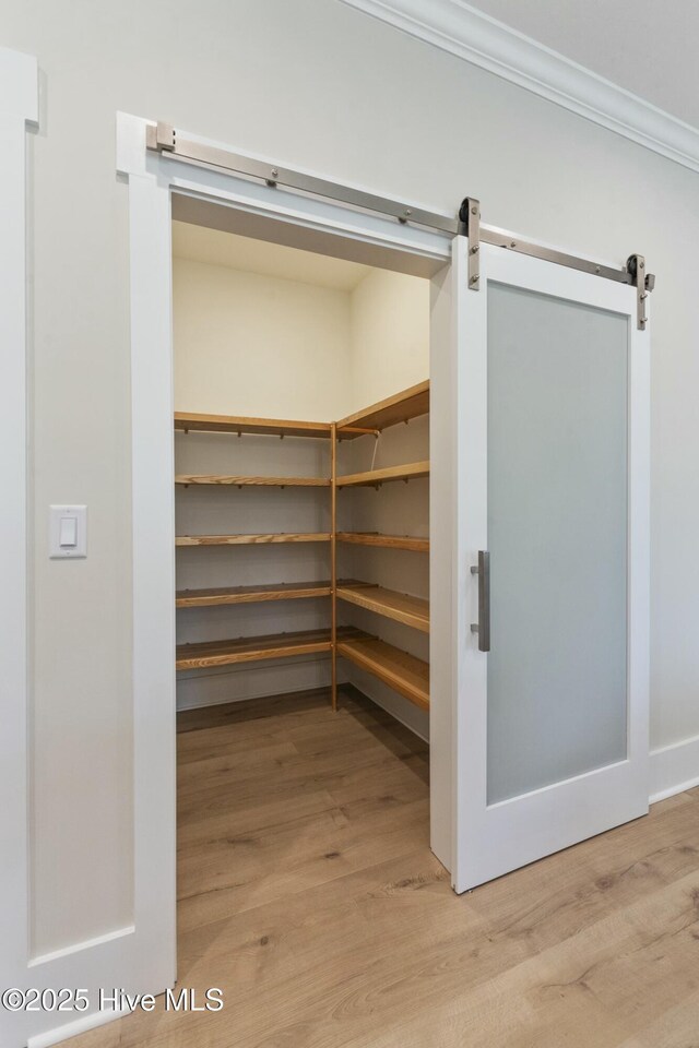 bathroom featuring an enclosed shower, vanity, and ornamental molding