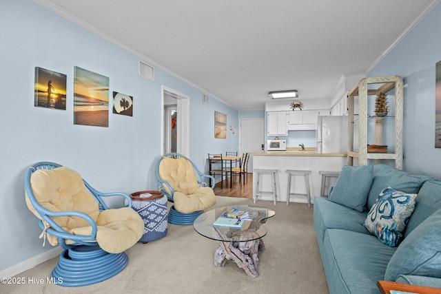 living room with light colored carpet and ornamental molding