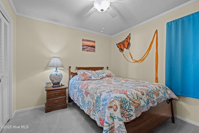 carpeted bedroom with ornamental molding, ceiling fan, a textured ceiling, and a closet