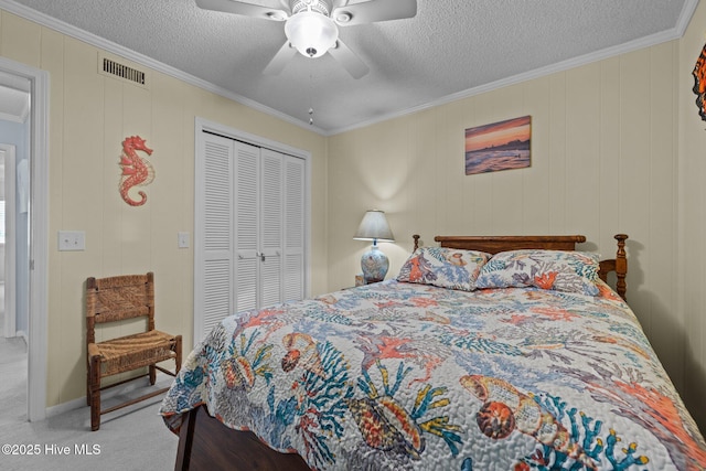 bedroom with crown molding, a closet, light carpet, and a textured ceiling