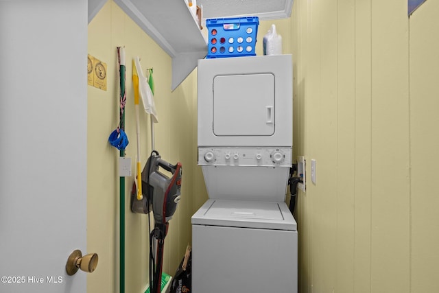 laundry area featuring stacked washer and dryer