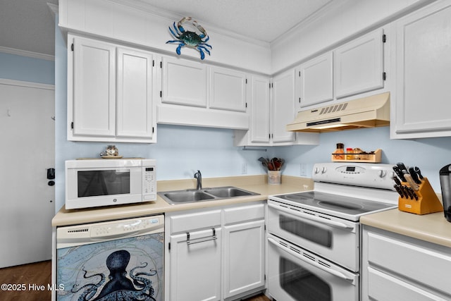 kitchen with sink, crown molding, white appliances, white cabinets, and washer / clothes dryer