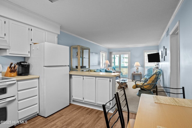 kitchen featuring crown molding, white appliances, light hardwood / wood-style flooring, premium range hood, and white cabinets