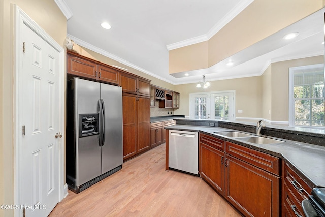 kitchen featuring stainless steel appliances, crown molding, sink, and a wealth of natural light