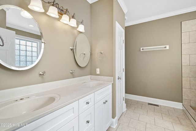 bathroom featuring crown molding, tile patterned floors, and vanity