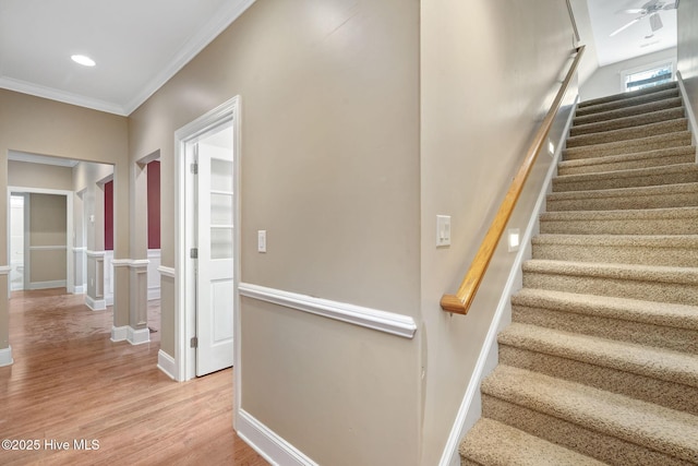 stairway featuring ornamental molding and hardwood / wood-style floors