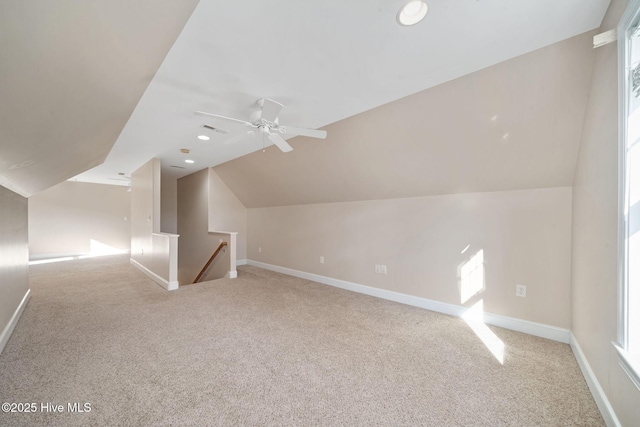 additional living space with lofted ceiling, carpet flooring, and ceiling fan