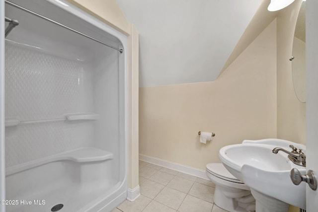 bathroom with walk in shower, lofted ceiling, toilet, and tile patterned flooring