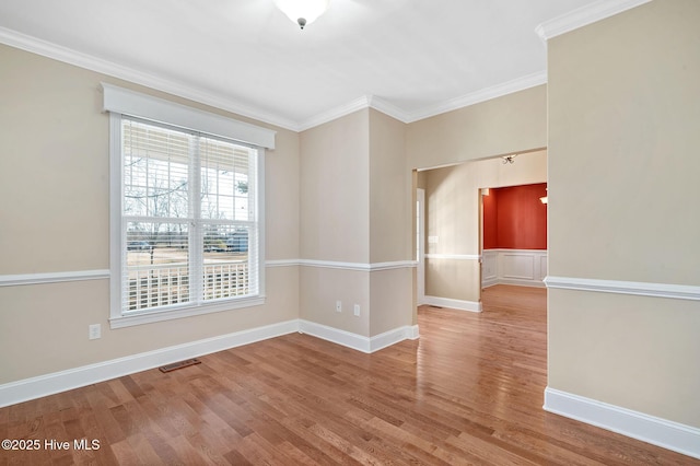 unfurnished room with hardwood / wood-style flooring and crown molding