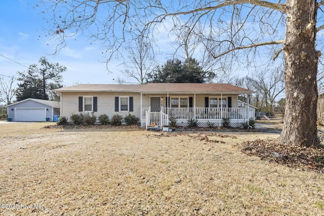 single story home with a porch, a garage, an outdoor structure, and a front lawn