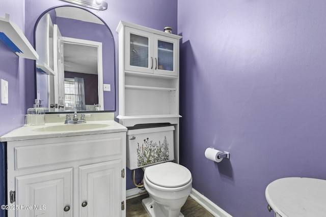 bathroom featuring vanity and toilet