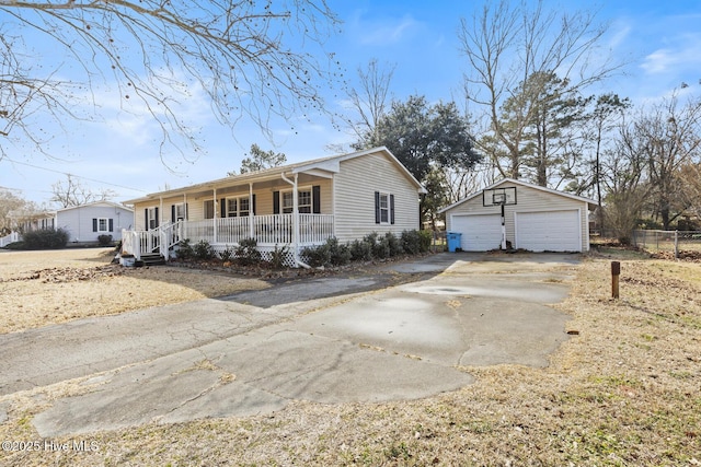 ranch-style home with a garage, an outdoor structure, and covered porch