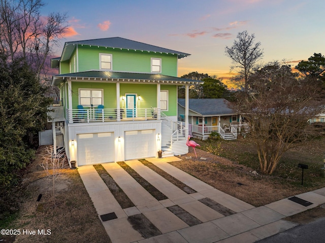 view of front facade with a garage and a porch