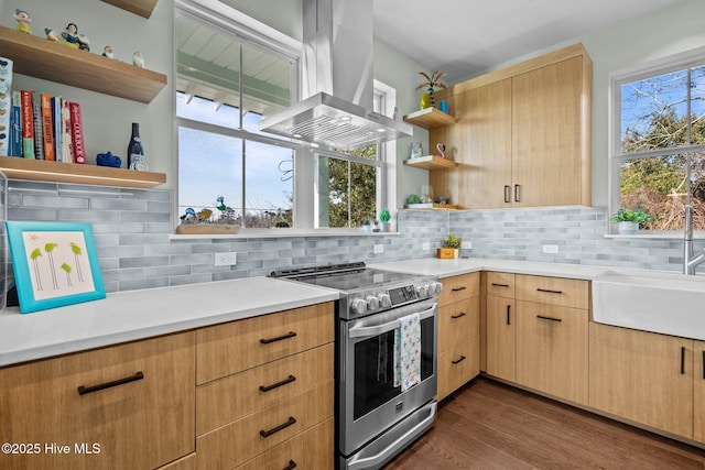 kitchen with dark wood-type flooring, light brown cabinetry, island range hood, stainless steel electric range, and decorative backsplash