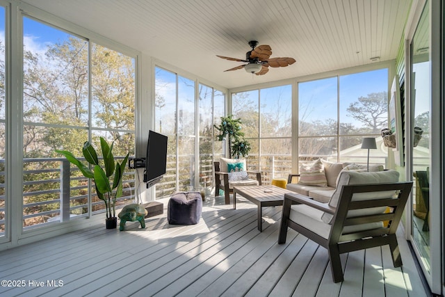 sunroom featuring ceiling fan