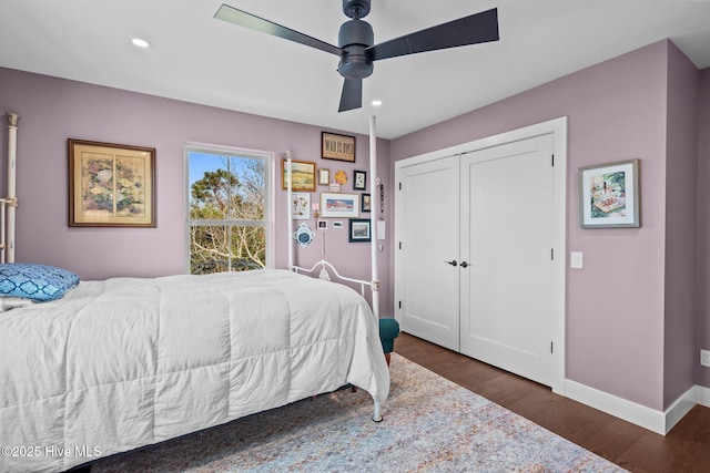 bedroom with dark wood-type flooring, ceiling fan, and a closet