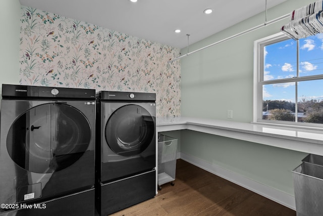 clothes washing area featuring wood-type flooring and washing machine and clothes dryer