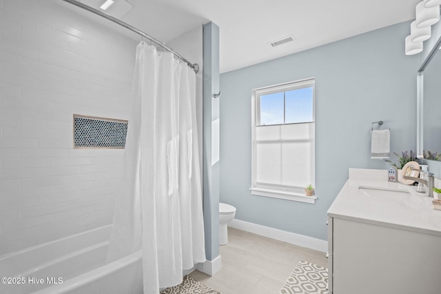 full bathroom with vanity, shower / bath combo, and toilet