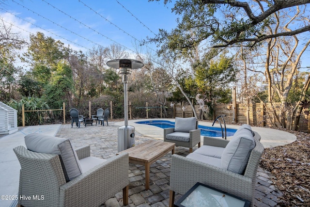 view of patio with a fenced in pool and outdoor lounge area