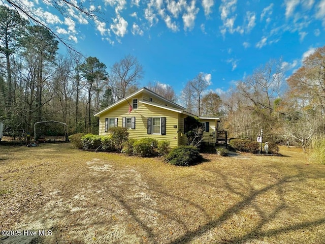 view of property exterior with a yard