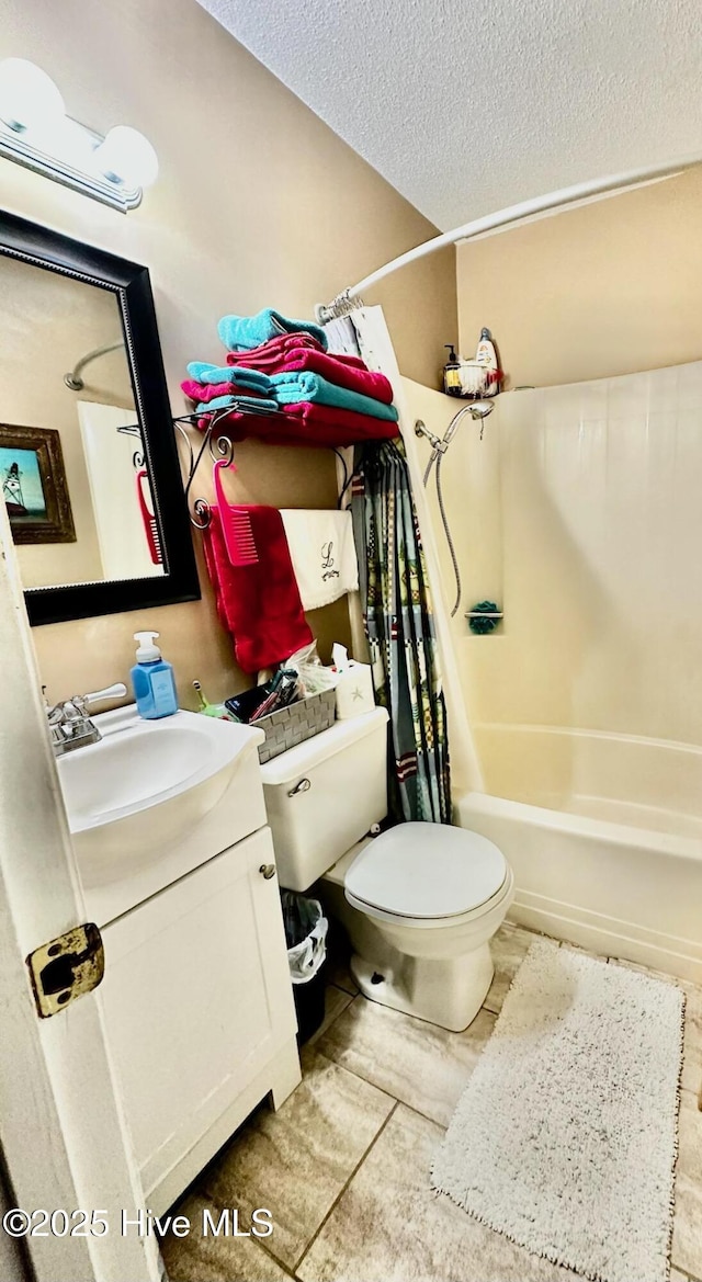 full bathroom featuring vanity, toilet, shower / bath combination with curtain, and a textured ceiling