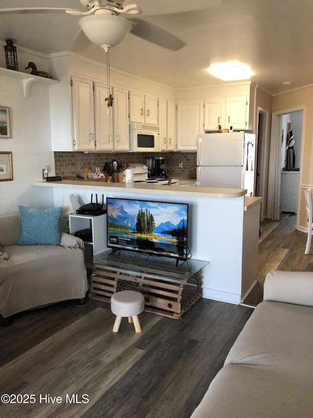 living area featuring ceiling fan, dark wood-style floors, and ornamental molding