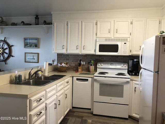 kitchen with white cabinets, white appliances, light countertops, and a sink