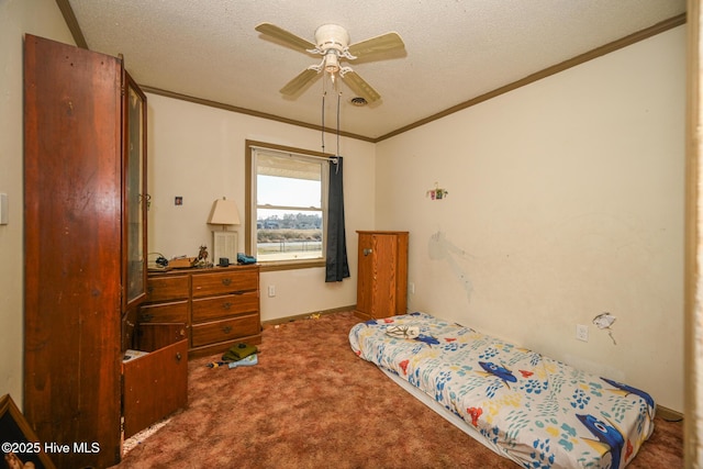 carpeted bedroom featuring ceiling fan, ornamental molding, and a textured ceiling